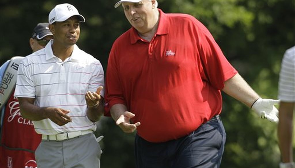 Greenbrier resort owner and future West Virginia Gov. Jim Justice talks to Tiger Woods at the resort in White Sulphur Springs, W. Va., on July 4, 2012. (AP)