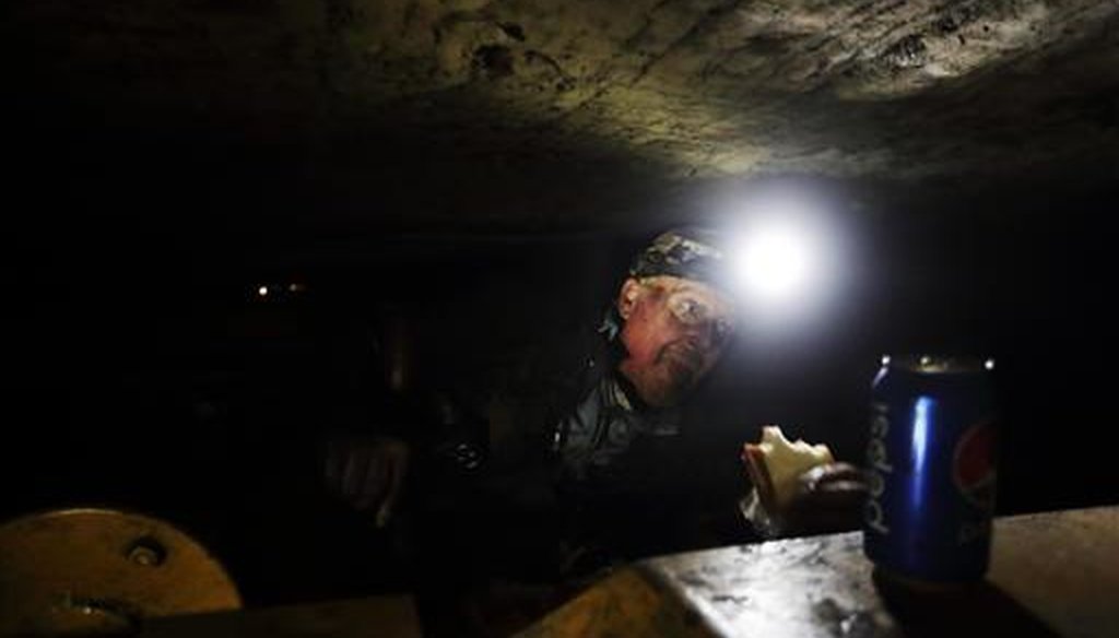 Coal miner Scott Tiller eats a sandwich during his lunch break in a mine less than 40-inches high in Welch, W.Va. (AP/David Goldman)