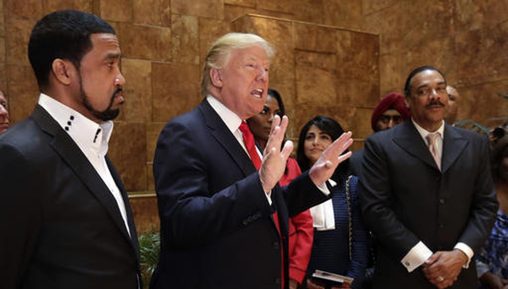 Pastor Darrell Scott, at left, listens as then-candidate Donald Trump speaks at Trump Tower on April 18, 2016.