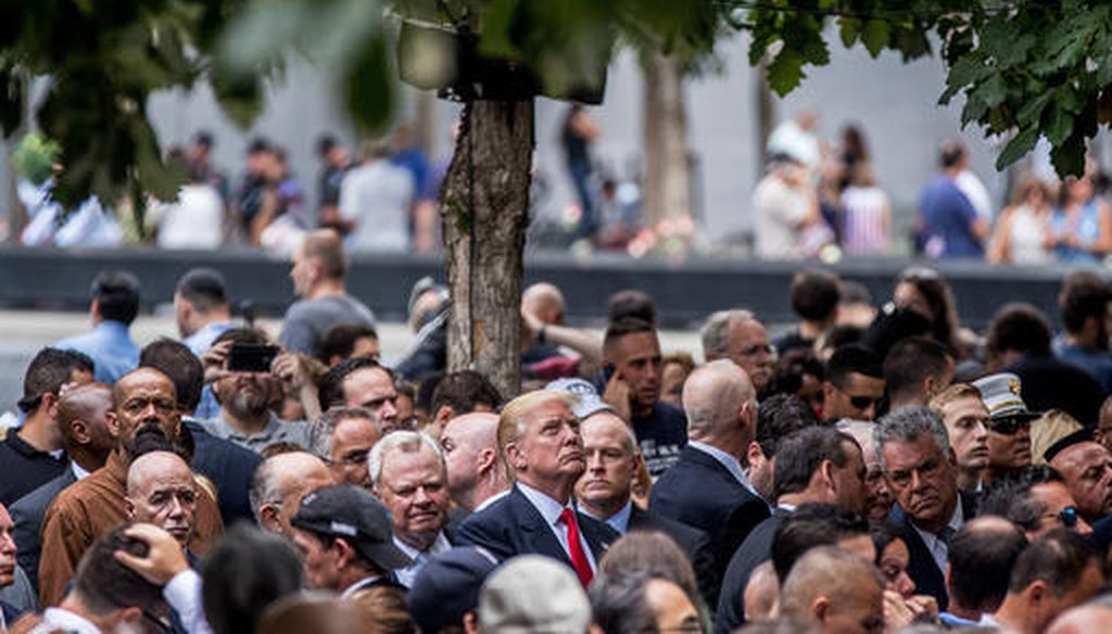 Then Republican presidential candidate Donald Trump, center, attends a ceremony at the Sept. 11 memorial, in New York, Sunday, Sept. 11, 2016 (AP).