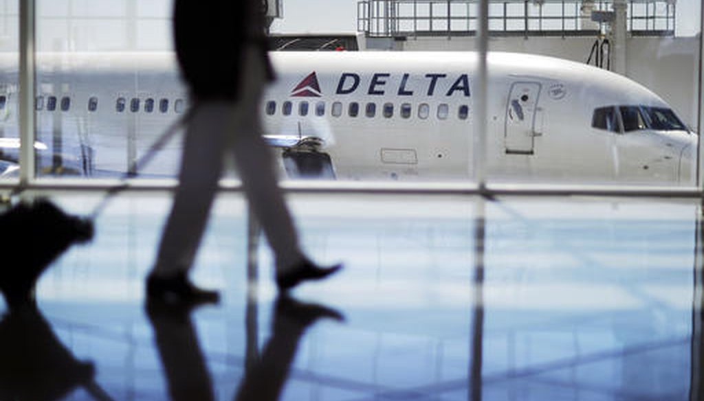 In this Thursday, Oct. 13, 2016, photo, a Delta Air Lines jet sits at a gate at Hartsfield-Jackson Atlanta International Airport in Atlanta. (AP Photo/David Goldman)