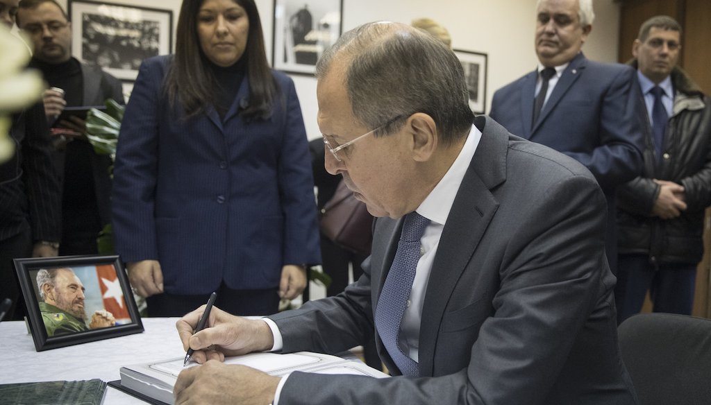 Russian Foreign Minister Sergey Lavrov writes a message for the late Cuban leader Fidel Castro in a book of condolences at the Cuban Embassy to Russia on Nov. 29, 2016. (AP)