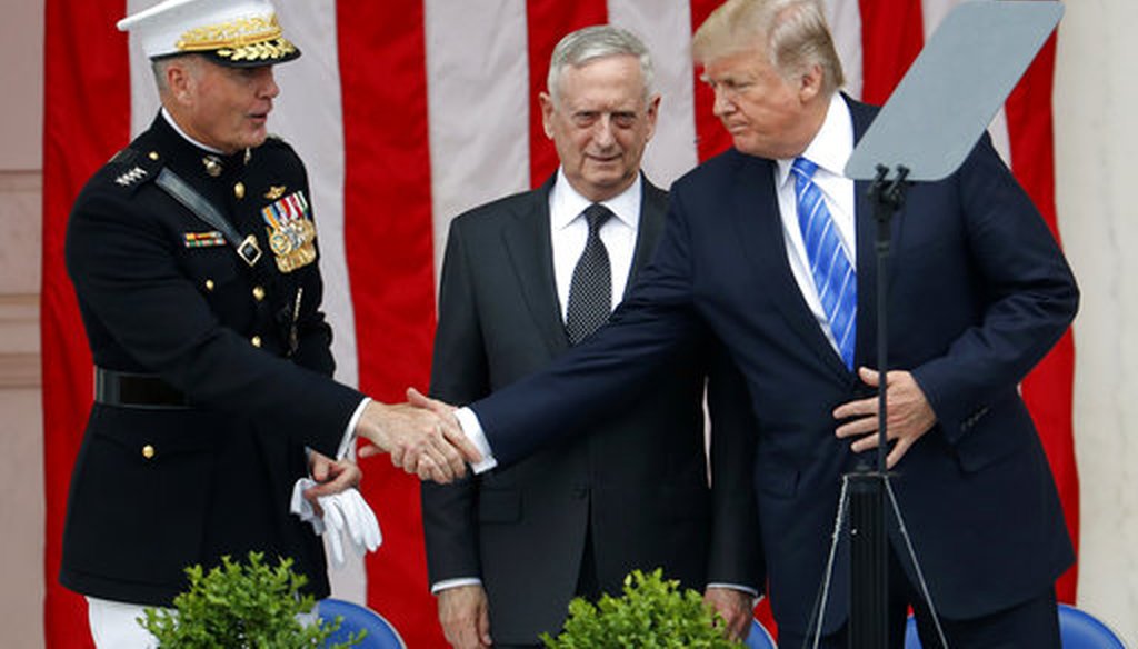 President Donald Trump, right, shakes hands with Joint Chiefs Chairman Gen. Joseph Dunford, left, as Defense Secretary Jim Mattis, center, watches at Arlington National Cemetery on May 29, 2017. (AP)