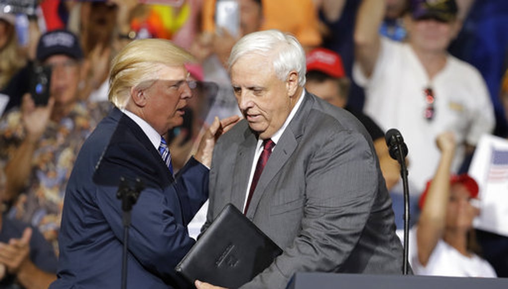 President Donald Trump talks with West Virginia Gov. Jim Justice during a rally on Aug. 3, 2017, in Huntington, W.Va. (AP)