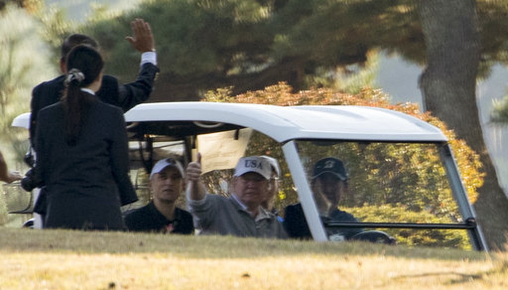 President Donald Trump, center, waves as Japanese Prime Minister Shinzo Abe, right, and he finish playing golf at Kasumigaseki Country Club, Sunday, Nov. 5, 2017, in Kawagoe, Japan. (AP Photo/Andrew Harnik)