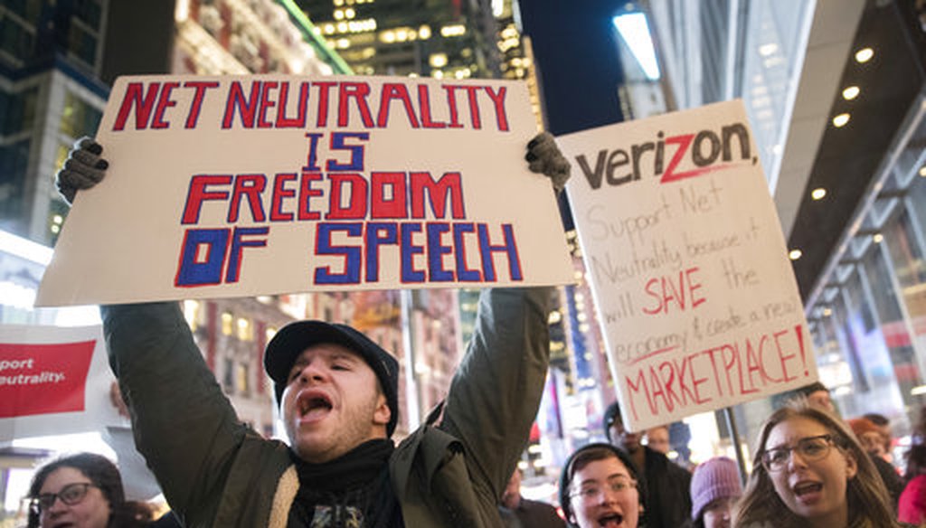 Demonstrators rally in support of net neutrality outside a Verizon store, Thursday, Dec. 7, 2017, in New York. (AP Photo/Mary Altaffer)