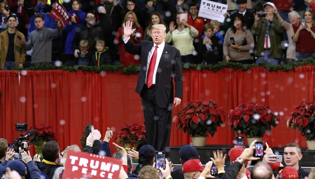 President Donald Trump waves to supporters during a rally in Pensacola, Fla., Dec. 8, 2017, as fake snow falls after his speech. (AP)