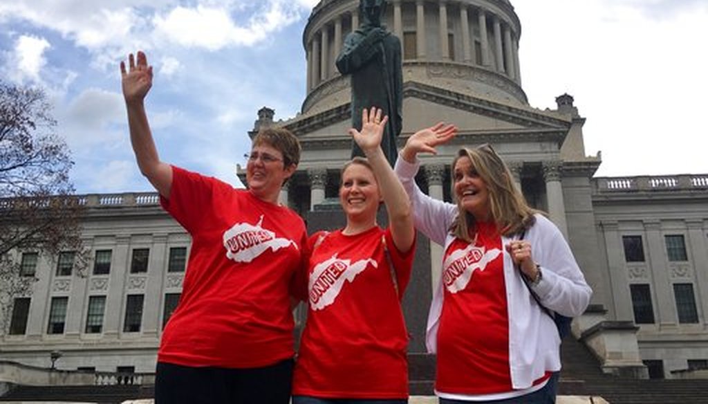 Striking teachers Michelle Myers, left, Holly O’Neil, center, and Suzanne Varner of McNinch Primary School in Moundville, W.Va., wave to passing cars outside the state capitol in Charleston, W.Va, on Feb. 23, 2018. (AP)