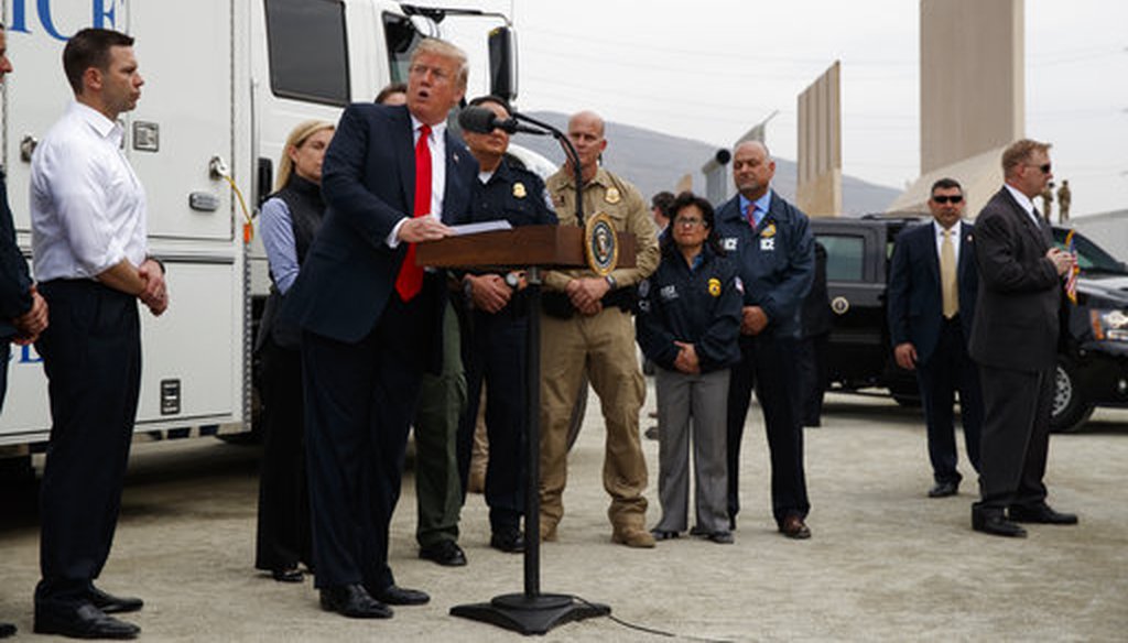 President Donald Trump talks with reporters after reviewing border wall prototypes, Tuesday, March 13, 2018, in San Diego. (AP Photo/Evan Vucci)