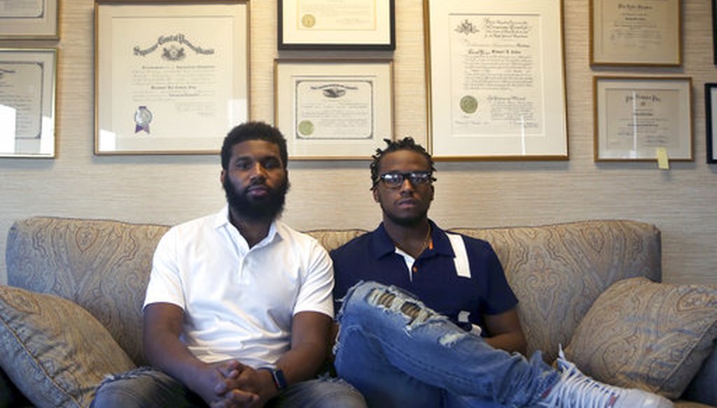 Rashon Nelson, left, and Donte Robinson, right, both 23, sit on their attorney's sofa as they pose for a portrait following an interview with the Associated Press Wednesday April 18, 2018 in Philadelphia. (AP Photo/Jacqueline Larma)