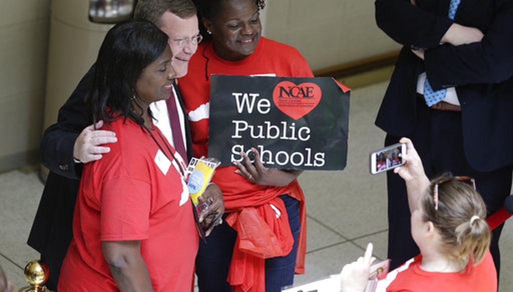 House speaker Tim Moore poses for a a photo with educators during a teachers rally at the General Assembly in Raleigh, N.C., Wednesday, May 16, 2018. (AP/Gerry Broome)