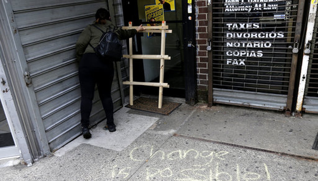 A message is written in chalk on the sidewalk outside campaign offices of Alexandria Ocasio-Cortez in the Queens borough of New York, Wednesday, June 27, 2018. 