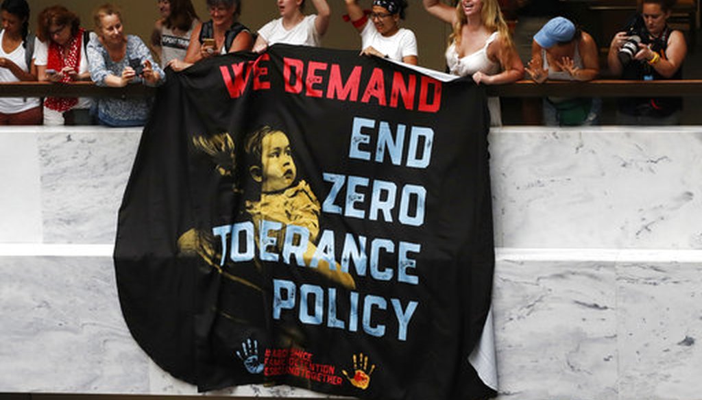Women hold a sign that says "we demand end zero tolerance policy," in a hallway during a protest of the separation of immigrant families June 28, 2018, on Capitol Hill in Washington. (AP Photo/Jacquelyn Martin)