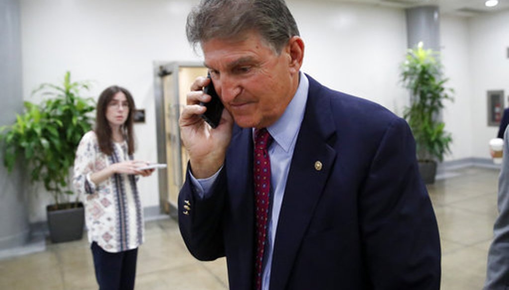 Sen. Joe Manchin, D-W.Va., walks with his phone on Capitol Hill on July 11, 2018. (AP/Alex Brandon)