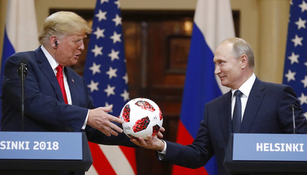 Russian President Vladimir Putin gives a soccer ball to U.S. President Donald Trump during a press conference after their meeting in Helsinki, Finland, on July 16, 2018. (AP/Alexander Zemlianichenko)