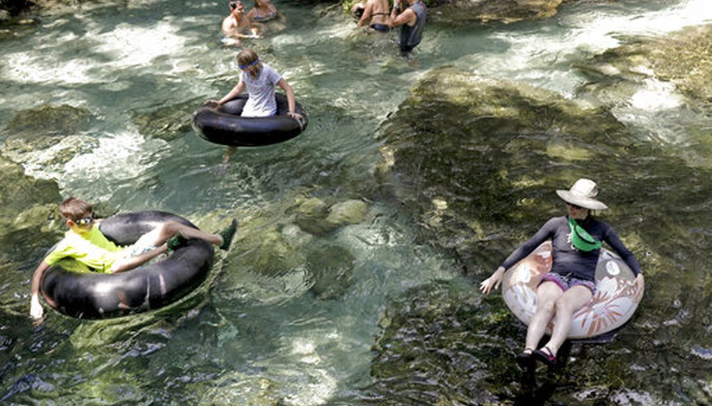 Park guests take advantage of the 68 degree year round water temperature as they cool off on a hot day tubing down the Rock Springs run at Kelly Park in Apopka, Fla., Thursday, Aug. 16, 2018. (AP)