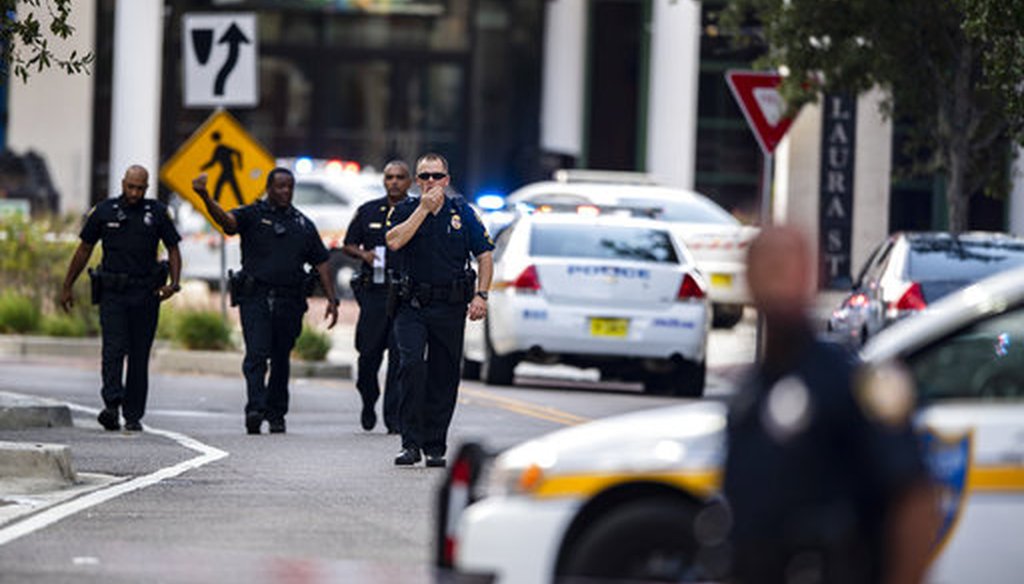 Police seen after a shooting at the Jacksonville Landing in Jacksonville, Aug. 26, 2018. (AP Photo/Laura Heald)