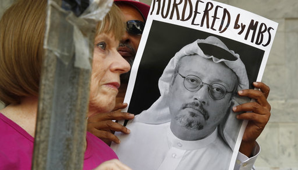 People hold signs during a protest at the Embassy of Saudi Arabia about the disappearance of Saudi journalist Jamal Khashoggi, Wednesday, Oct. 10, 2018, in Washington. (AP Photo/Jacquelyn Martin)