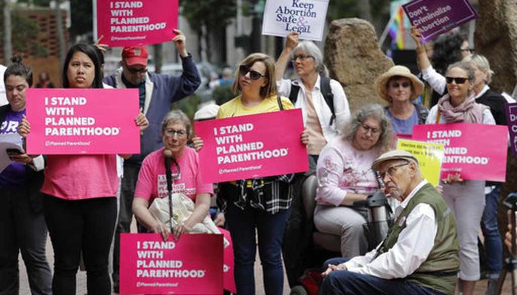 Protesters hold signs supporting Planned Parenthood in Seattle on July 10, 2018. (AP/Ted S. Warren)