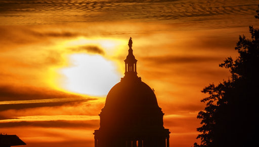 The rising sun silhouettes the U.S. Capitol dome at daybreak on Oct. 26, 2018. (AP/Alex Brandon)
