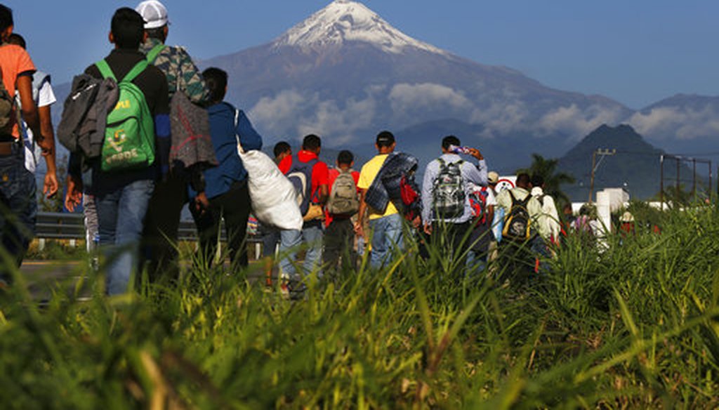 Central American migrants begin their morning trek as part of a thousands-strong caravan hoping to reach the U.S. border, as they face the Pico de Orizaba volcano upon departure from Cordoba, Veracruz state, Mexico, Nov. 5, 2018. (AP Photo/Marco Ugarte)