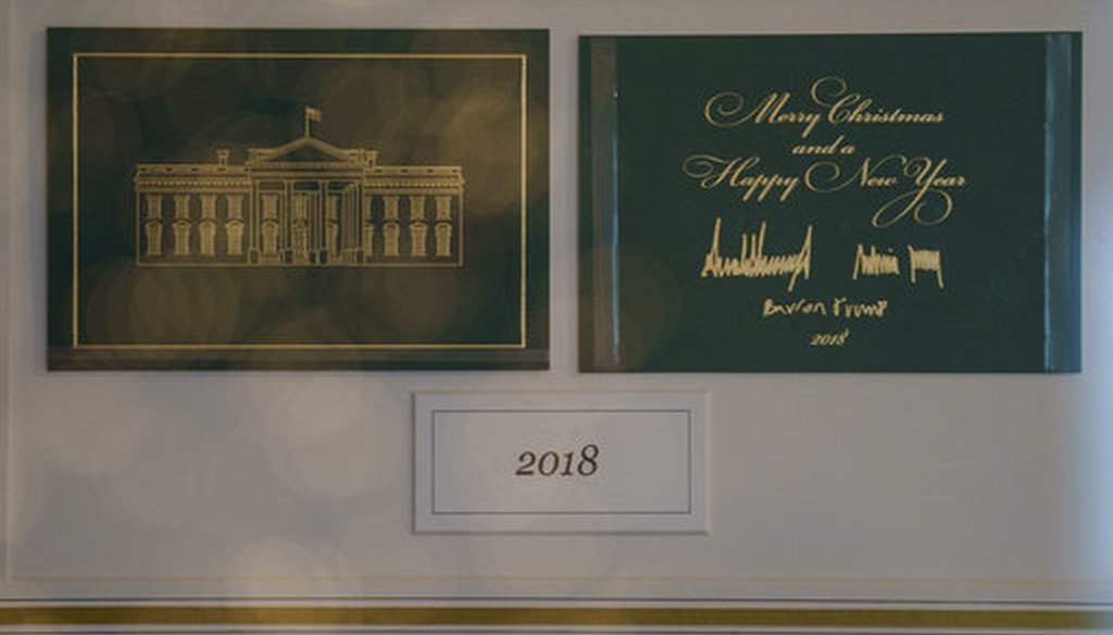 The First Family's holiday card is seen behind glass in Booksellers during the 2018 Christmas preview at the White House in Washington, Monday, Nov. 26, 2018. (AP Photo/Carolyn Kaster)