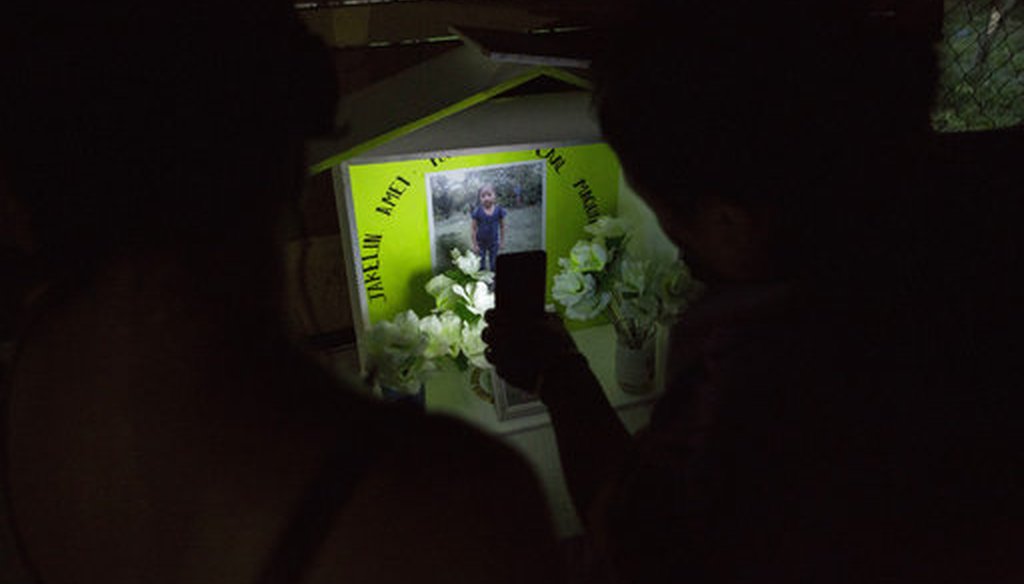 Neighbors illuminate a memorial of Jakelin Caal Maquin at her grandfather's house in San Antonio Secortez, Guatemala, Sunday, Dec. 23, 2018. (AP Photo/ Oliver de Ros)