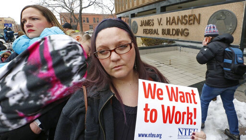 IRS worker Christine Helquist joins other federal workers rallying outside the Federal Building in Ogden, Utah, on Jan. 10, 2019, as a government shutdown continued. (AP)