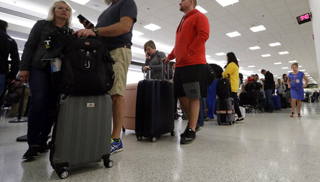 Passengers wait in line at Miami International Airport on Jan. 11, 2019. (AP)