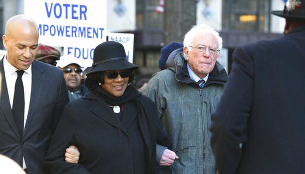 Sen. Cory Booker, D-N.J., left, and Sen. Bernie Sanders, I-Vt., right, march with NAACP President Brenda Murphy Jan. 21, 2019, march in Columbia, S.C. (AP Photo)