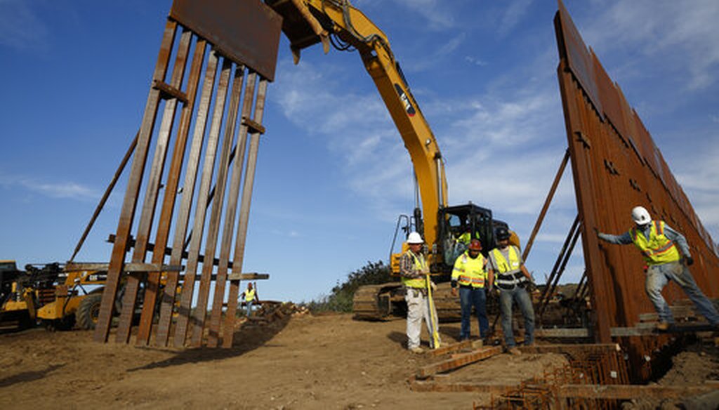 In this Jan. 9, 2019 file photo, construction crews install new border wall sections seen from Tijuana, Mexico. The government is working on replacing and adding fencing in various locations. (AP)