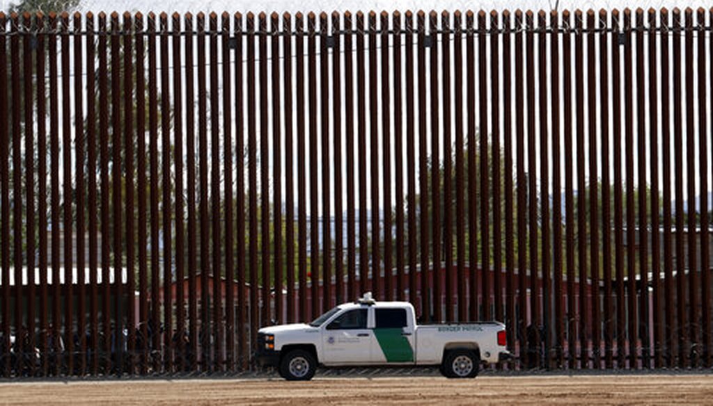 In this April 5, 2019, file photo, a U.S. Customs and Border Protection vehicle sits near the barrier as President Donald Trump visits a new section of the border fence with Mexico in Calexico. (AP/Jacquelyn Martin)