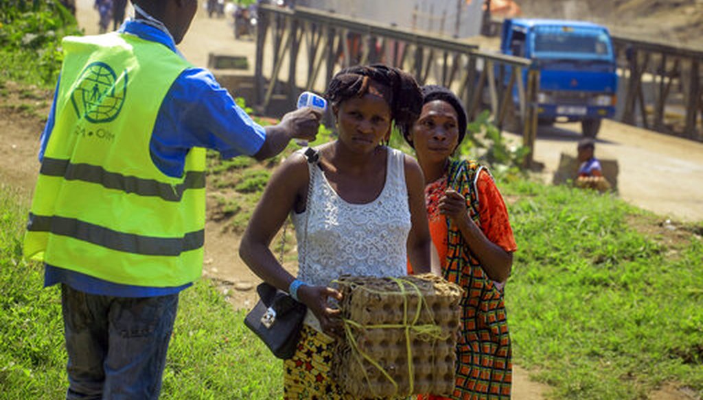 People crossing the border have their temperature taken to check for symptoms of Ebola at the border crossing near Kasindi, eastern Congo on June 12, 2019. (AP)