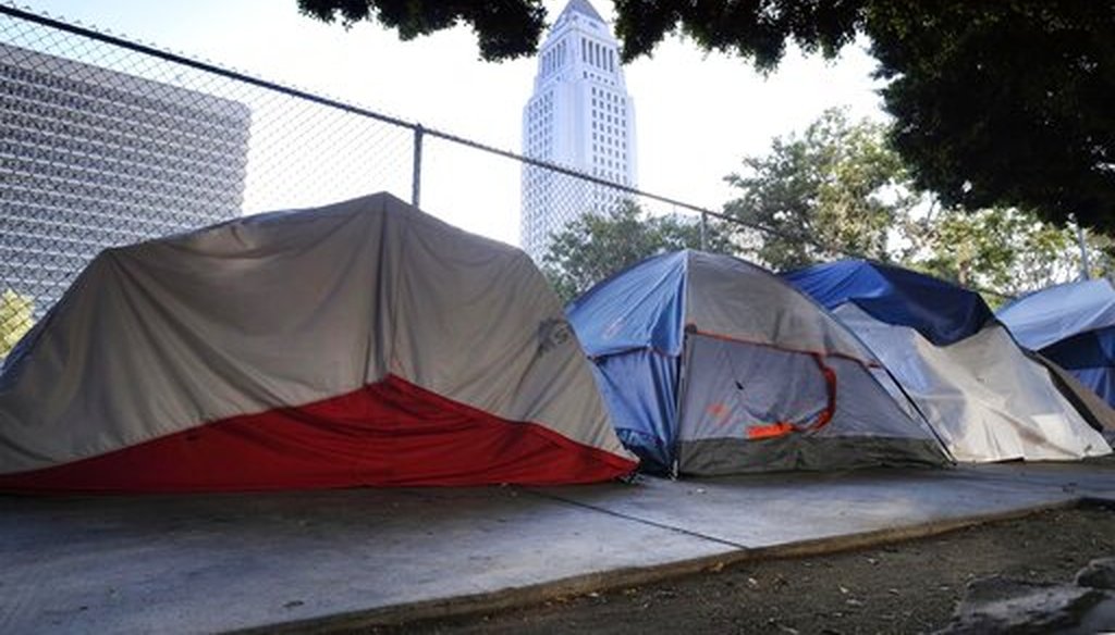 Los Angeles City Hall is seen behind a homeless tent encampment along a street in downtown Los Angeles on July 1, 2019. (AP/Vogel)