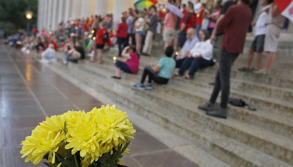 People attend a candlelight vigil at the Ohio Statehouse in Columbus after mass shootings in Ohio and Texas. (AP)