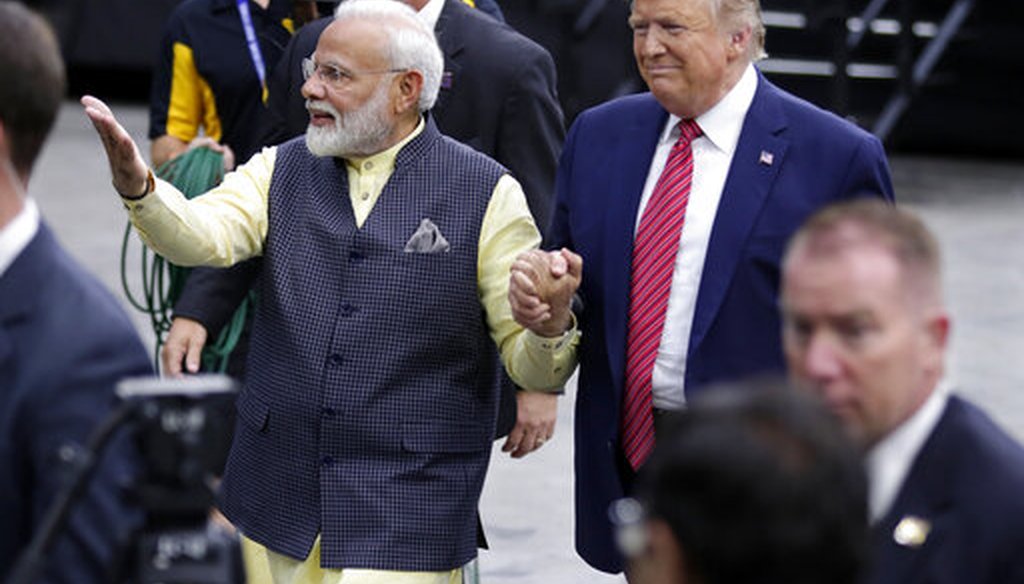 India Prime Minister Narendra Modi and President Donald Trump walk the perimeter of the arena floor to greet attendants after Modi's speech during the "Howdi Modi" event September 22, 2019, at NRG Stadium in Houston. (AP/Michael Wyke)