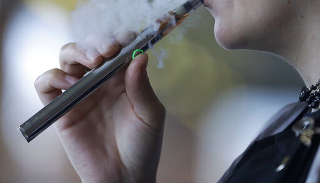 A woman uses an electronic cigarette in this Oct. 4, 2019, file photo. (AP)
