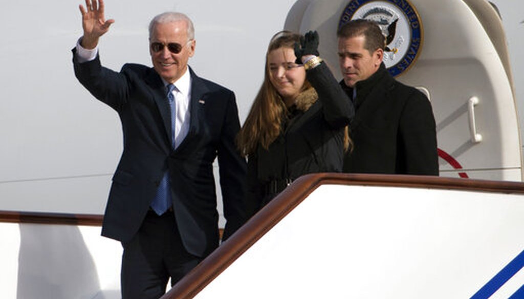 Then-Vice President Joe Biden waves as he walks out of Air Force Two with son Hunter Biden in Beijing on Dec. 4, 2013. (AP via pool)