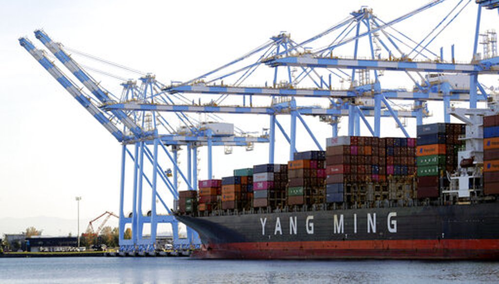 Cargo cranes take containers off of a Yang Ming Marine Transport Corporation boat at the Port of Tacoma in Tacoma, Wash., in 2019. (AP)