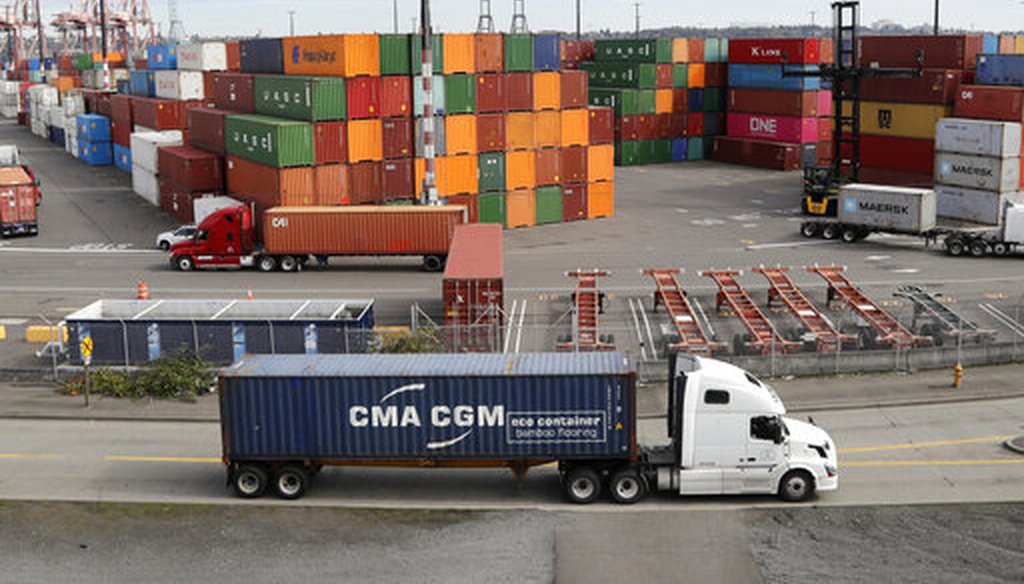 Trucks haul shipping containers at a terminal on Harbor Island in Seattle in 2019. (AP)