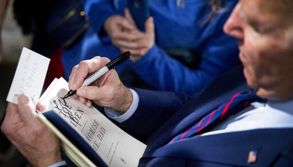 Democratic presidential candidate Joe Biden signs a copy of his book "Promise Me, Dad" at a campaign rally Jan. 5, 2020, in Davenport, Iowa. (AP)