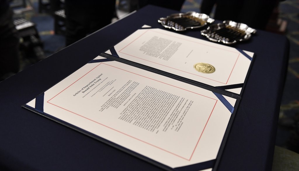 The articles of impeachment against President Donald Trump on the desk before House Speaker Nancy Pelosi of Calif. (AP images)