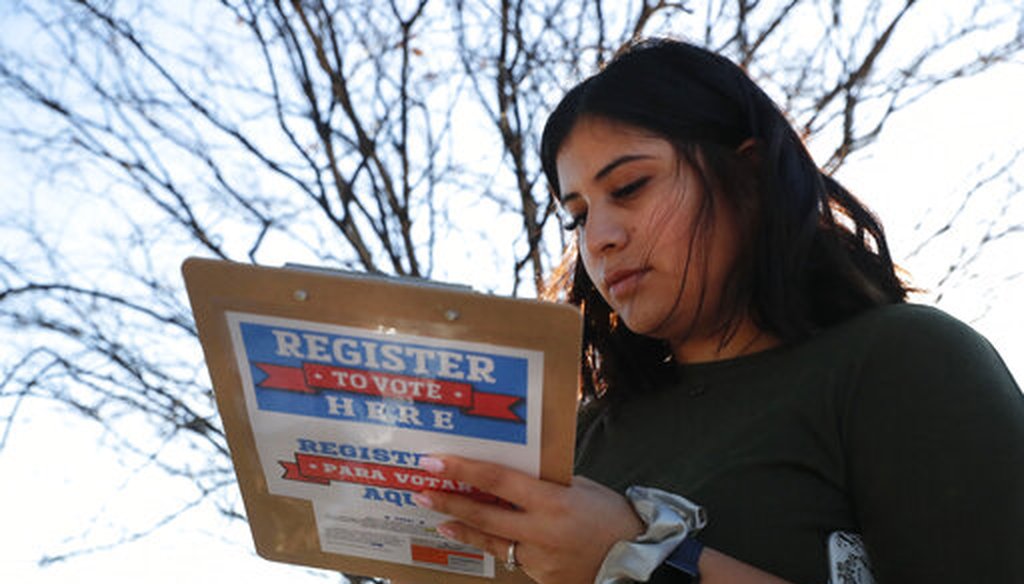 Karina Shumate, 21, a college student studying stenography, fills out a voter registration form in Richardson, Texas, on Jan. 18, 2020. (AP)