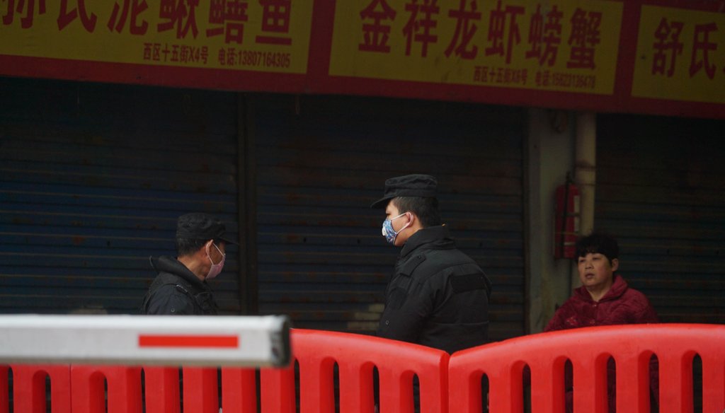 Police stand guard outside Wuhan Huanan Wholesale Seafood Market, where a number of people related to the market fell ill with a virus in Wuhan, China, on Jan. 21, 2020. (AP)