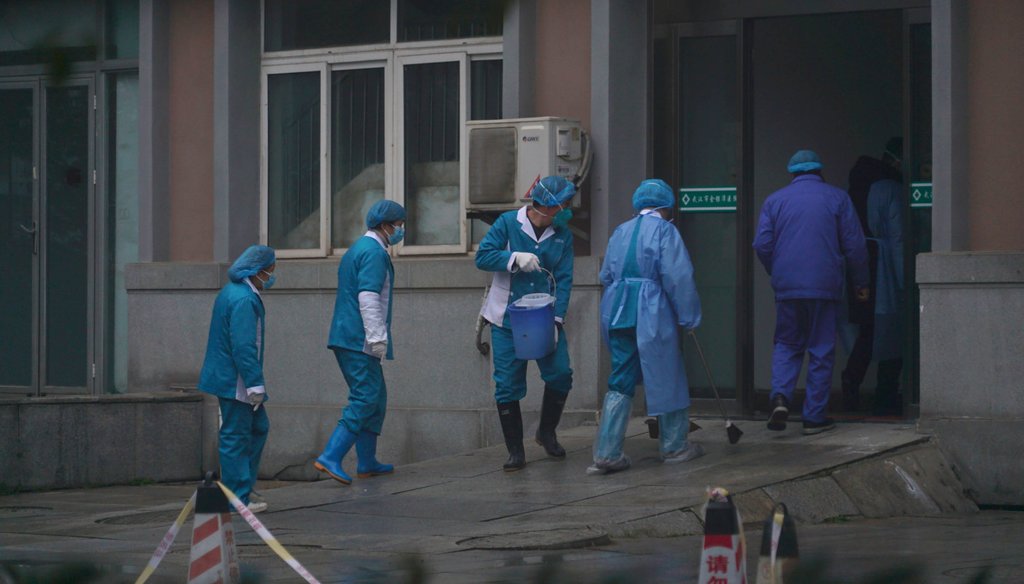 Hospital staff wash the emergency entrance of Wuhan Medical Treatment Center, where some infected with a new virus are being treated, in Wuhan, China, on Jan. 22, 2020. (AP)