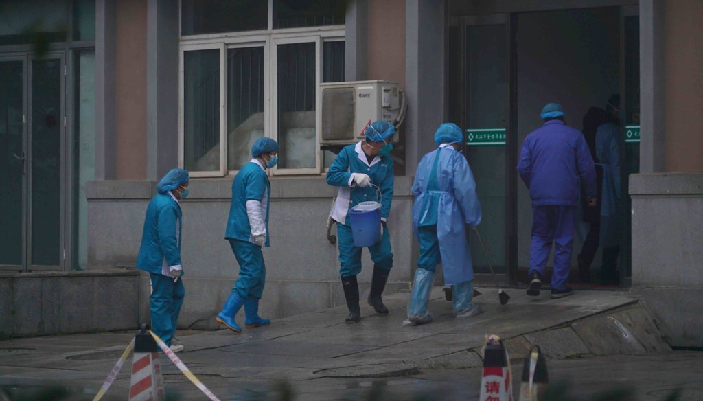 Hospital staff wash the emergency entrance of Wuhan Medical Treatment Center, where some infected with the coronavirus were being treated, in Wuhan, China, on Jan. 22, 2020. (AP)