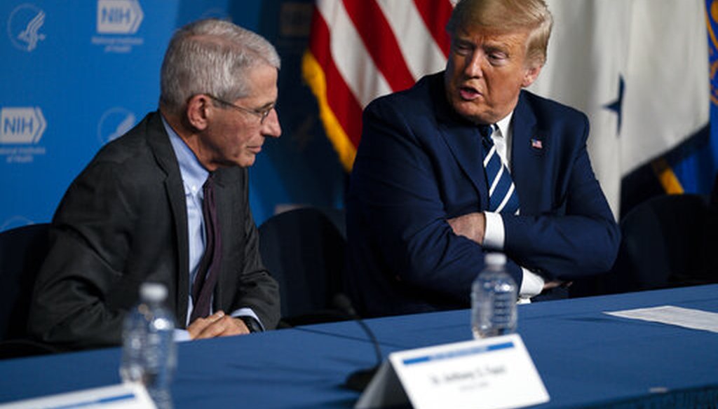 Dr. Anthony Fauci, director of the National Institute of Allergy and Infectious Diseases, listens as President Donald Trump speaks during a coronavirus briefing at the National Institutes of Health on March 3, 2020, in Bethesda, Maryland. (AP/Vucci)