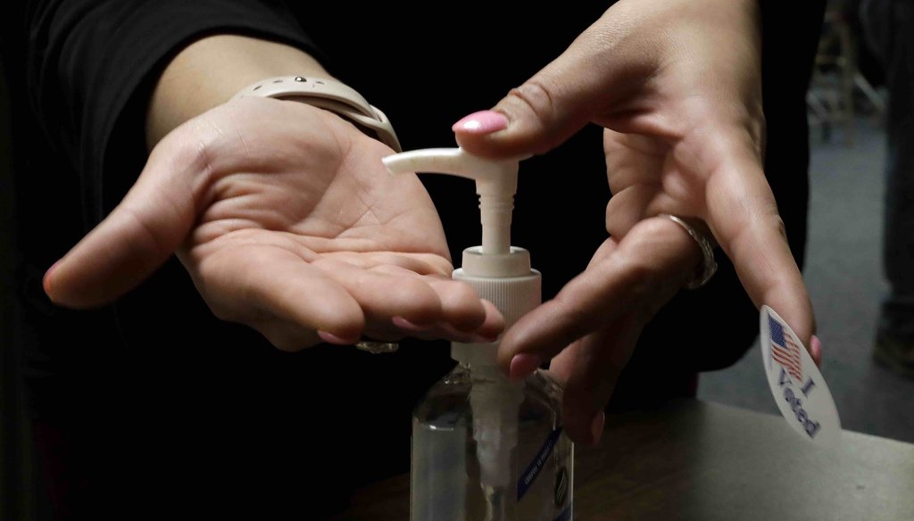 A woman uses hand sanitizer after voting in the presidential primary election at the the Summit View Church of the Nazarene on March 10, 2020, in Kansas City, Mo. (AP)