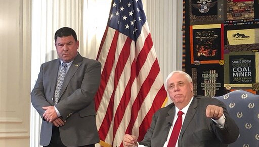 West Virginia Gov. Jim Justice, right, and West Virginia Secondary School Activities Commission Executive Director Bernie Dolan address a news conference on March 12, 2020, about the coronavirus. (AP)