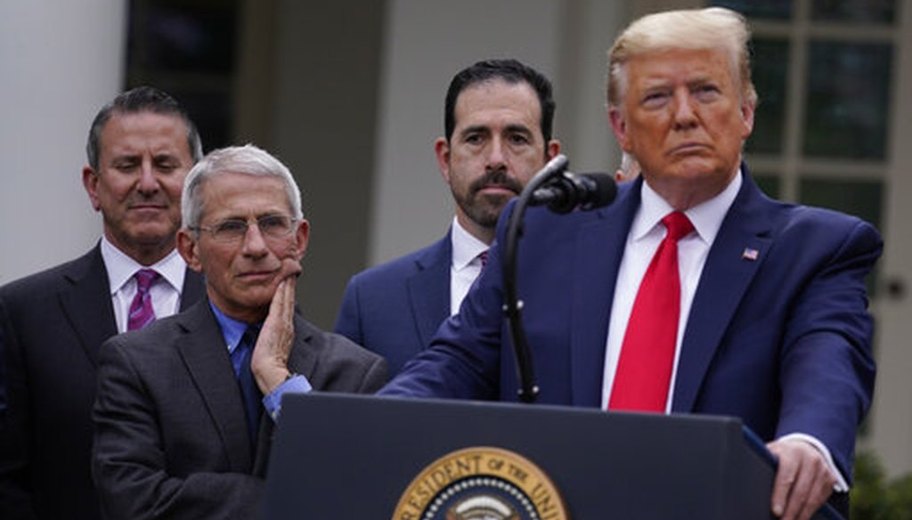 Dr. Anthony Fauci, director of the National Institute of Allergy and Infectious Diseases, and President Donald Trump listen during a coronavirus news conference at the White House on March 13, 2020, in Washington. (AP/Vucci)